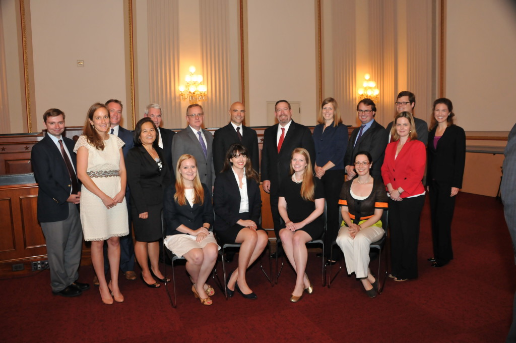 A group of House Armed Services Committee staff gather to celebrate their accomplishments.