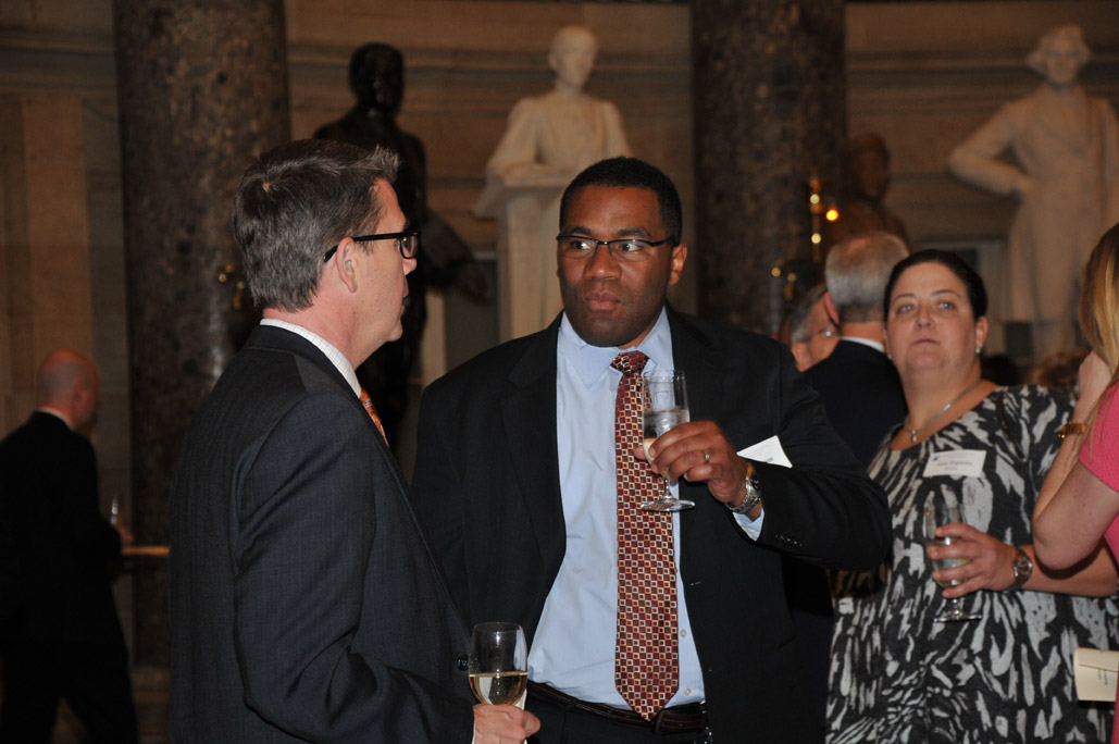 Chris Long and Al Thompson (both with United Technologies) chat during the reception.