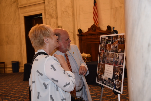 Steve Livengood, USCHS, and a Senate photographer studied the collage of historic photos of the Committee.