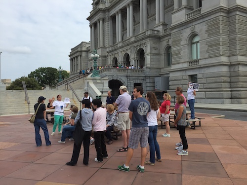 Carla Smith guides a group in front of the Thomas Jefferson Building.
