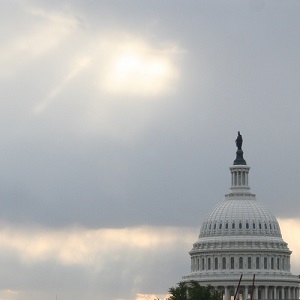 Capitol Dome with sunbeams breaking through clouds